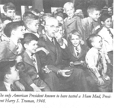 President Truman eats a Hum Mud. Joe Mastroddi (left) Koestler Twin nest to Trumans shoulder, Joe Sawicki behind Trumans hand, Alan Rosenberg above Sawicki, Koestler Twin lower right. T. Yocom